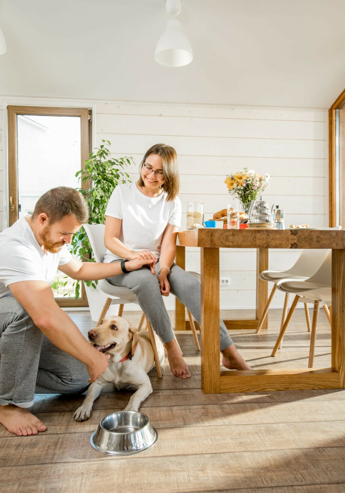 Young couple with dog at home | Junge's Flooring