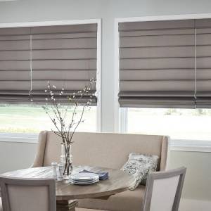 Picture of taupe colored roman shades on dining room windows
